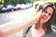 Mother hitting daughter on the street in daylight – Parent abuse outdoor in public – Hand slapping a teen’s face – Concept of awareness raised against aggressive bully parents