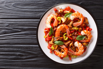 Wall Mural - Stir Fried Shrimp with mushrooms and vegetables close-up on a plate. horizontal top view