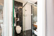 © rilueda - Interior of a luxury hotel bathroom with glass shower cabin