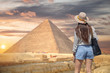 tourist walks on the background of the pyramids in Giza.
