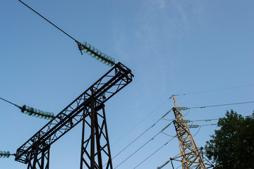 high-voltage metal tower against the sky