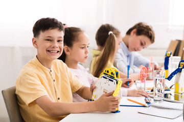 Poster - Stem education. Boy creating robot at lab
