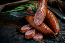 Bavarian Smoked Sausages From Pork Cut On A Wooden Board. Rustic Style