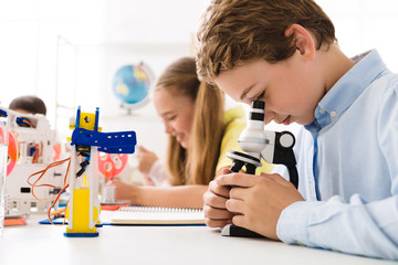 Poster - Boy looking at microscope with robot nearby