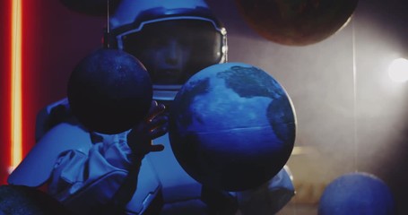 Wall Mural - Student in space suit revolving planet model