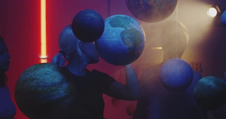 Wall Mural - Young teacher teaching astronomy with planet models