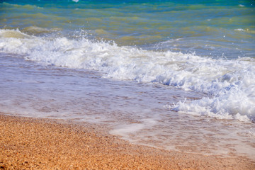 Sea waves. Sea of Crimea. High waves in clear weather. Sunny day at sea. Background blue sea waves. Sand beach. Clean beach.