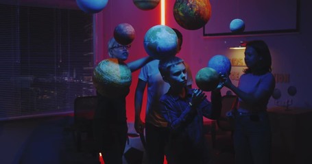 Wall Mural - Young teacher teaching astronomy with planet models