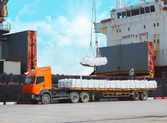 Wall Mural - Loading sugar bag product to vessel activities at port, vessel crane pick jumbo bag from trailer load to vessel hole. Agriculture product import export.