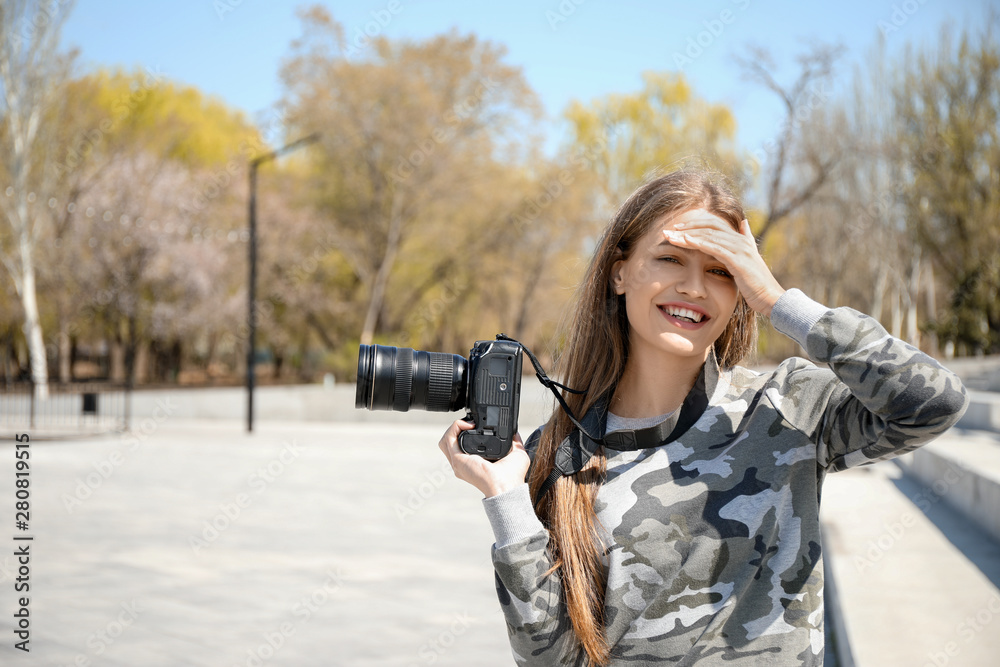 Beautiful female photographer outdoors