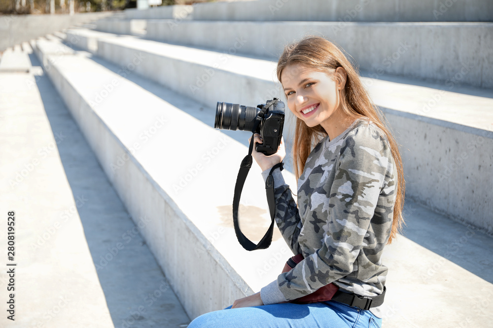 Beautiful female photographer outdoors