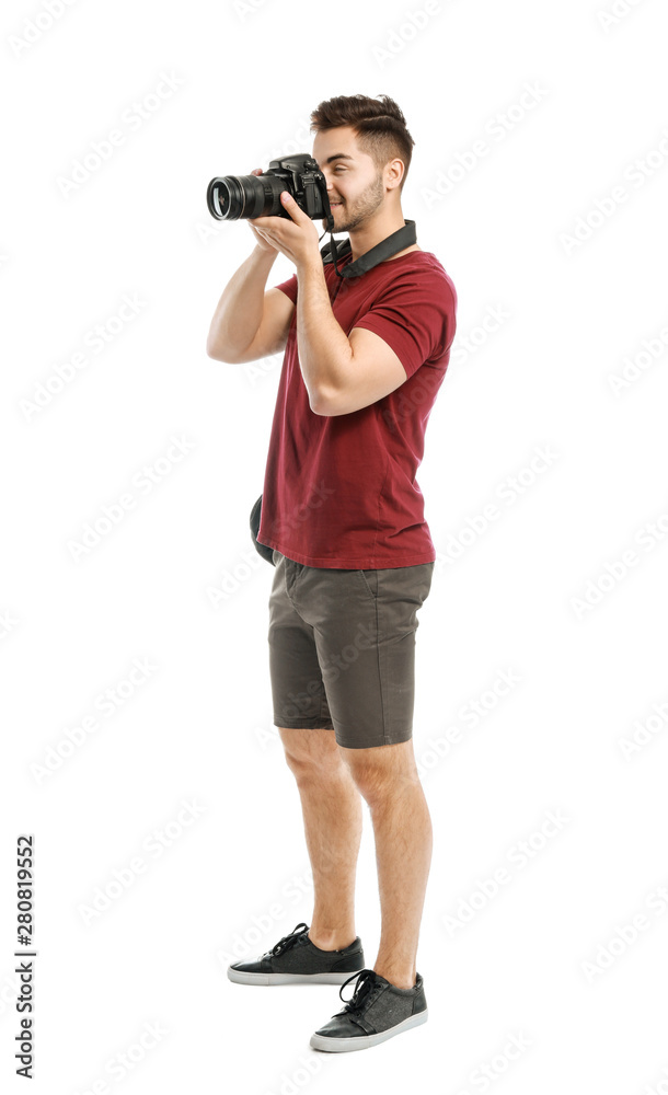 Young male photographer on white background