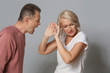 © Pixel-Shot - Quarrelling middle-aged couple on grey background