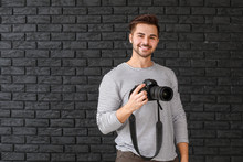 Young Male Photographer On Dark Background
