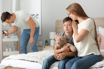 Poster - Woman calming little son during family quarrel