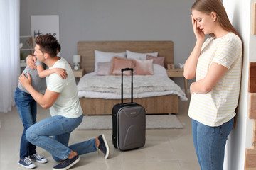 Upset woman and her husband saying goodbye to his son before leaving family