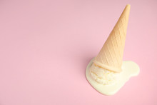 Melted  Vanilla Ice Cream In Wafer Cone On Pink Background. Space For Text
