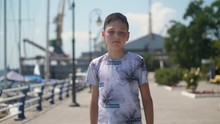 Cheery Small Boy Gong Along Dnipro Quay With Cranes In Summer In Slow Motion