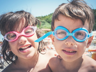 summer fun, summer beach, portrait of two happy children wearing swimming goggles 2