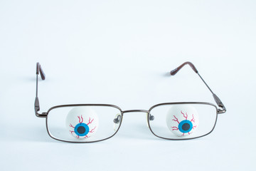 Two artificial eyes with glasses