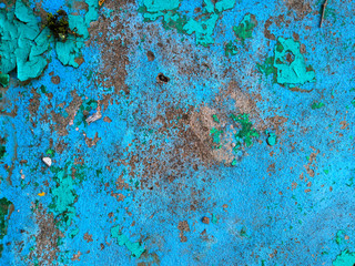 Old grunge vintage background: rusty metal surface with blue paint flaking and cracking texture