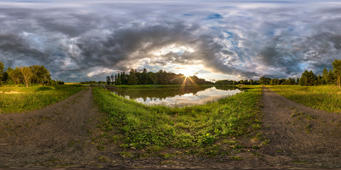 Wall Mural - full seamless spherical hdri panorama 360 degrees angle view on the shore of lake in evening before storm with black clouds in equirectangular projection, ready VR virtual reality content