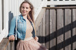 © Ulia Koltyrina - Young cheerful girl. Young blonde woman smiling in a denim jacket