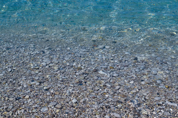 Wall Mural - Pebbles under water. Marine background. Pure sea water. Clear sea