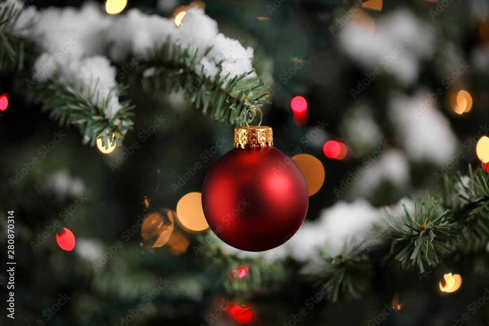 Traditional artificial Christmas tree with red ball ornament with ...