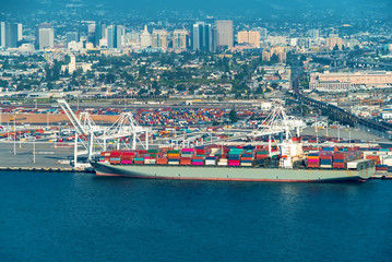 Oakland Harbor port terminal with cargo ship and shipping containers