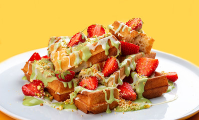 Wall Mural - Belgian waffles with pistachio cream topping and strawberries