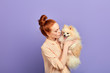 © alfa27 - pleasant girl sending her weekend with pet, expressing tender feeling and emotion. close up portrait, isolated blue background, studio shot