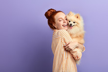 Girl And Her Pet Are On The Ninth Cloud Of Happiness, Funny Girl Holding The Dog In Tight Embrace