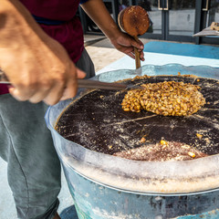 Wall Mural - Traditional sweet nut making in Asia.