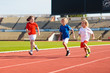 © famveldman - Child running in stadium. Kids run. Healthy sport.