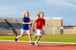 © famveldman - Child running in stadium. Kids run. Healthy sport.