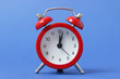 © White bear studio  - mechanical alarm clock on a colored background