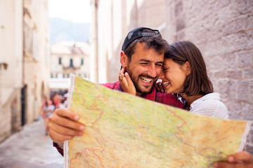 Wall Mural - Happy love tourist couple using map at travel,exploring new town