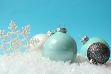 Christmas balls and snow on a colored background. Christmas and New Year background.