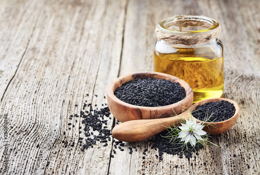 Black cumin oil with seeds and flower nigella sativa - obrazy, fototapety, plakaty 