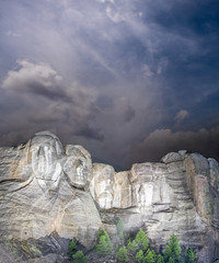 Fototapete - Mt. Rushmore national memorial park in South Dakota at night, presidents faces illuminated against black sky