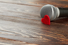 Gray Microphone On Dark Wooden Background. Microphone With Red Heart And Copy Space. Valentines Day Concept.