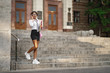 © Mironifamily - African-American student descends the stairs with books in their hands.