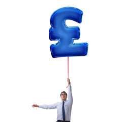 Businessman flying on british pound sign inflatable balloon