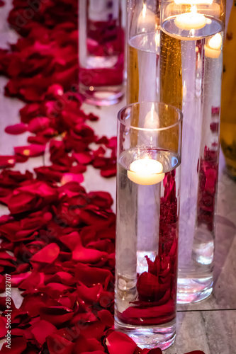 Beautiful Candles Float In Clear Vases And Rose Petals Line The