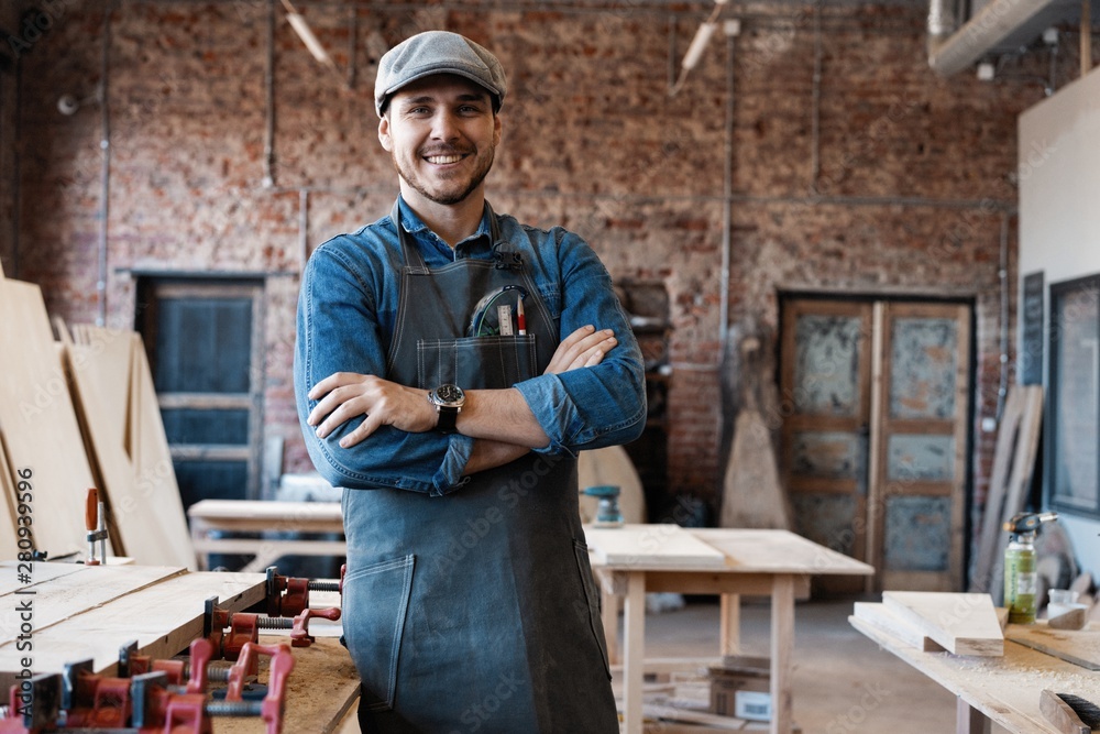 Successful handsome businessman with stylish cap work in carpentry - obrazy, fototapety, plakaty 