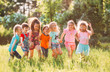© davit85 - Large group of kids, friends boys and girls running in the park on sunny summer day in casual clothes .