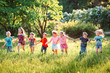 © davit85 - Large group of kids, friends boys and girls running in the park on sunny summer day in casual clothes .