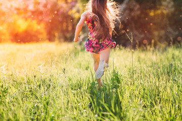 Wall Mural - Large group of kids, friends boys and girls running in the park on sunny summer day in casual clothes .