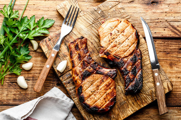 Wall Mural - grilled meat, a portion of two pork loin steaks barbecue